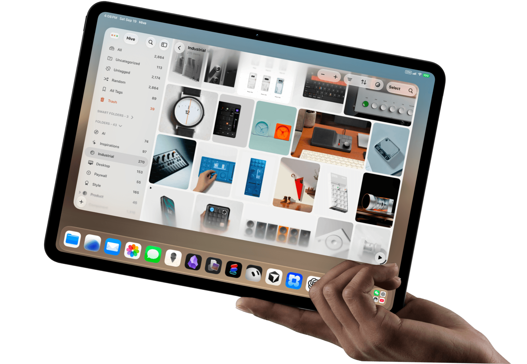 A hand holding an iPad open to a Hive library grid