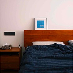 Bedroom with a wooden headboard and navy bedding