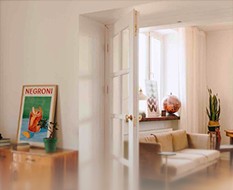 Room with a Negroni poster and glass doors